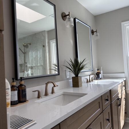 Chic bathroom makeover in Fairfax Station featuring a modern vanity, glass-enclosed shower, and elegant tilework by Kitchen and Bath Shop.