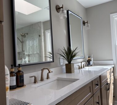 Chic bathroom makeover in Fairfax Station featuring a modern vanity, glass-enclosed shower, and elegant tilework by Kitchen and Bath Shop.