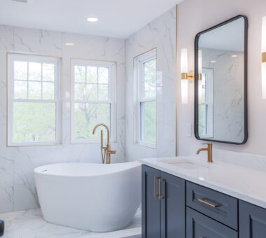 New Market bathroom remodel with blue cabinets, white tub, and a clean modern design.