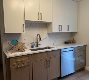 Warm-toned kitchen with wooden cabinets, modern appliances, and a minimalist design in Alexandria, VA.