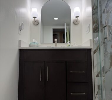 Modern bathroom with cool-toned tiles, glass shower, and minimalist design in Alexandria