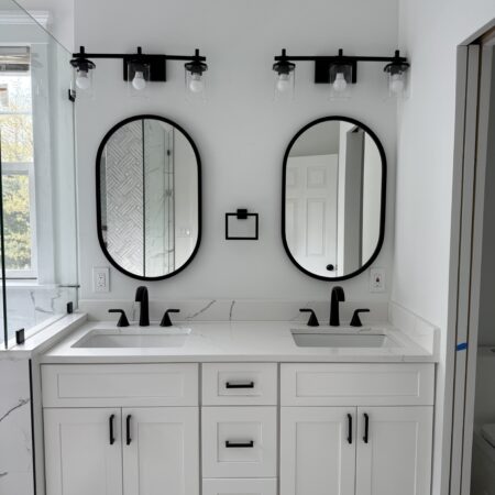 White bathroom with sleek design, modern fixtures, and soft lighting
