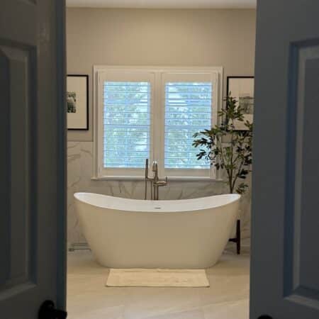 Spacious modern bathroom with LED-lit mirror and minimalist design
