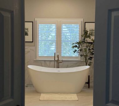 Spacious modern bathroom with LED-lit mirror and minimalist design